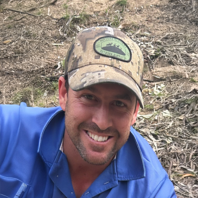 Broden Imrie from Lake Cargelligo Taxi Truck smiling outdoors in a work shirt and cap.
